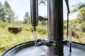 Alcohol mashine in a village courtyard, on a blurred background. Preparation of an intoxicating beverage. Close-up.