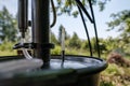 Alcohol mashine in a village courtyard, on a blurred background. Preparation of an intoxicating beverage. Close-up.