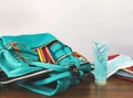 Alcohol sanitizer hand gel, medical face mask, school backpack with school supplies on wooden table on white background Royalty Free Stock Photo