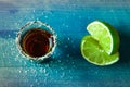 Alcohol shots with lime and salt on wood blue table