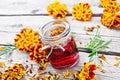 Alcohol tincture of marigolds in jar on board Royalty Free Stock Photo