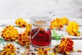 Alcohol tincture of marigolds in jar on old board Royalty Free Stock Photo