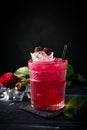 Alcoholic cocktail with blackberries, mint and ice on a dark wooden background. Refreshing red drink Royalty Free Stock Photo