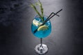 Alcoholic cocktail blue curacao with ice, lemon and cocktail tubes Royalty Free Stock Photo