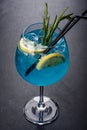 Alcoholic cocktail blue curacao with ice, lemon and cocktail tubes Royalty Free Stock Photo