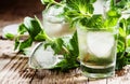 Alcoholic cocktail, mint tea with rum in small glasses with ice