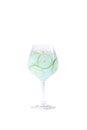 Alcoholic drink blue lagoon with lime and ice stands on a white background