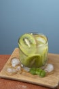 Alcoholic drink caipirinha based on kiwi and aguardente distilled cocktail drink and fruits Royalty Free Stock Photo