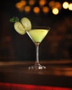 Alcoholic drink cocktail with slice of green apple In martini glass. Object at table on black background with beautiful Royalty Free Stock Photo