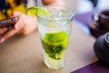 Alcoholic drink concept. Mojito with ice and lime in glass close up Royalty Free Stock Photo