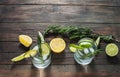 Alcoholic drink gin tonic cocktail with lemon, rosemary and ice on rustic wooden table, copy space. Royalty Free Stock Photo