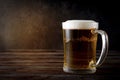 Alcoholic drink , light beer, beer mug on a dark wooden background Royalty Free Stock Photo