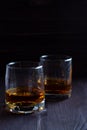 Glass of whiskey with ice on a wooden background. Royalty Free Stock Photo