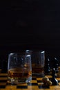 Glass of whiskey with ice on a wooden background. Royalty Free Stock Photo