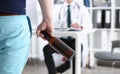 Alcoholic hold in hand empty bottle at doctor reception