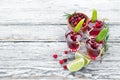 Alcoholic liqueur from a cranberry in a glass. Cranberry, lime, rosemary. On a rustic background.