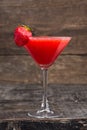 Alcoholic red strawberry drink in a glass, cocktail. Photography of drinks on a dark background Royalty Free Stock Photo