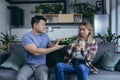 Alcoholic woman drinking hard alcohol at home, husband frustrated and annoyed, conflict in young family over alcohol Royalty Free Stock Photo