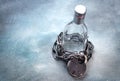 Alcoholism, alcohol addiction concept with alcohol drink bottle and chain with lock Royalty Free Stock Photo