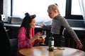 Alcoholism in family problem. Daughter aguring with her mother about drinking wine. Two people, woman and teenage girl