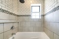 Alcove bathtub shower combo with ceramic and subway tiles wall with mosaic tiles trim in the middle