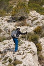 Alcoy, Spain, 07 03 2024: Octogenarian person hiking in the Alt de les Pedreres in Alcoy