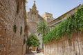 Alcudia, Spain - 9 July, 2023: Sant Jaume Church and castle walls, Alcudia, Mallorca