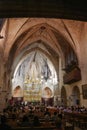 Alcudia, Spain - 9 July, 2023: Sunday service at the Sant Jaume Church in old town Alcudia, Mallorca