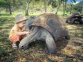 Aldabra giant tortoise and child Royalty Free Stock Photo