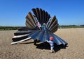 Scallop Shell Sculpture on Aldeburgh Beach with Children climbing on it.