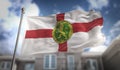 Alderney Flag 3D Rendering on Blue Sky Building Background