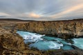 Aldeyjarfoss waterfall in Iceland at sunrise with golden clouds in the sky. Amazing landscape in beautiful tourist attraction. Won