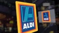 Aldi logo on the glass against blurred business center. Editorial 3D rendering Royalty Free Stock Photo