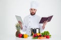 ?ale chef cook holding table computer and recipe book