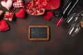Alentine`s Day with hearts, wine, corkscrew, glasses, gifts, a heart-shaped box and a blackboard