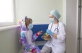 Easter in the hospital: the doctor nurse gives the girl a chocolate egg