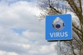 Alert sign with the inscription `virus`and the image of a medical mask