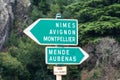 Ales, Occitanie, France, Green direction signs at the banks of the river Gardon, towards Nimes, Avignon and Montpellier