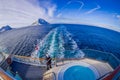 ALESUND, NORWAY - APRIL 04, 2018: Above outdoor view of man taking pictures of Hurtigruten voyage in cruise along