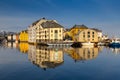 Alesund, Norway - April 14, 2018: Colorful architecture of Alesund reflected in the water of the harbour, Norway Royalty Free Stock Photo