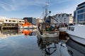 Alesund, Norway - April 14, 2018: Colorful architecture of Alesund reflected in the water of the harbour, Norway Royalty Free Stock Photo