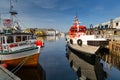 Alesund, Norway - April 14, 2018: Colorful architecture of Alesund reflected in the water of the harbour, Norway Royalty Free Stock Photo