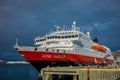ALESUND, NORWAY - APRIL 04, 2018: Outdoor view of Hurtigruten coastal vessel KONG HARALD, is a daily passenger and