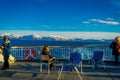ALESUND, NORWAY - APRIL 09, 2018: Outdoor view of unidentified people sitting and enjoying the landscape in Hurtigruten