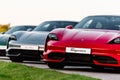 Alesund, Norway - May 31, 2020- luxury electric german sedans Porsche Taycan photographed during sunset. Three cars shot from