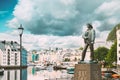 Alesund, Norway. Statue Of Young Sailor-fisher Boy On Brosundet Canal. Old Wooden Houses In Summer Day Royalty Free Stock Photo