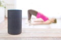 Alexa echo plus device with a fitness skill and a man doing some pushup workout at home. Empty copy space