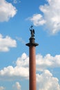 Alexander Column on a background of blue summer sky with cumulus clouds Royalty Free Stock Photo