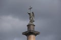 Alexander Column depicting and sculpture of angel  with raised arm holding a cross and a snake beneath on Palace Square. Royalty Free Stock Photo