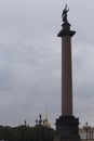 Alexander Column depicting and sculpture of angel with raised arm holding a cross and a snake beneath on Palace Square. Vertical